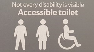 Tesco accessible toilet sign reads "Not every disability is visible".
