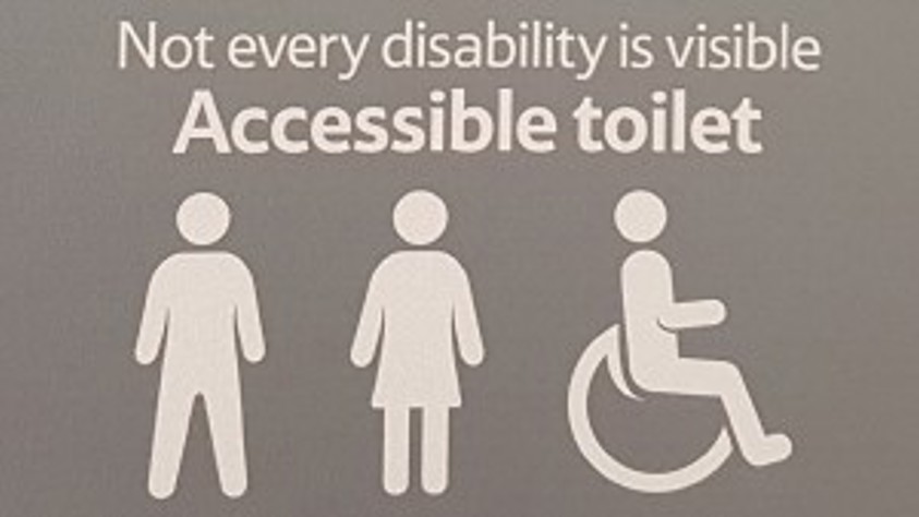 Accessible toilet sign reads "Not every disability is visible".