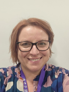 Portrait of a woman smiling. She is wearing a purple Crohn's & Colitis UK lanyard