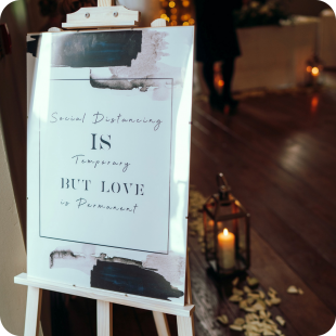 Wedding sign reads "Social Distancing is temporary but love is permanent".